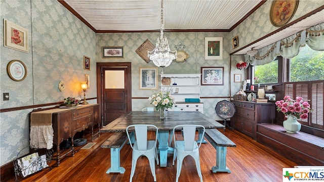 dining room with hardwood / wood-style floors, a notable chandelier, and crown molding