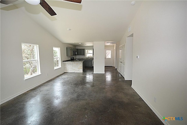 unfurnished living room with high vaulted ceiling and ceiling fan