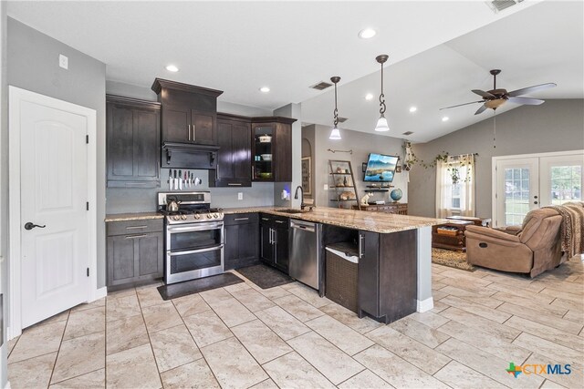 kitchen with stainless steel appliances, dark brown cabinets, sink, kitchen peninsula, and lofted ceiling