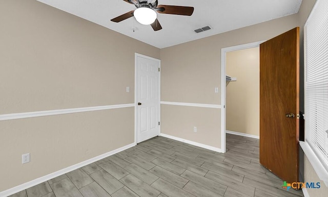 1117 Lindsey Cir, Belton, TX 76513 - unfurnished room with baseboards, visible vents, ceiling fan, and wood finish floors
