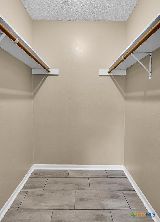 1117 Lindsey Cir, Belton, TX 76513 - walk in closet featuring wood tiled floor