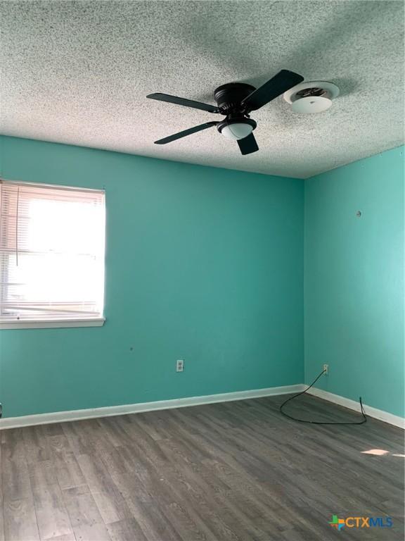 701 S 19th St, Copperas Cove, TX 76522 - unfurnished room featuring a textured ceiling, wood finished floors, and a ceiling fan