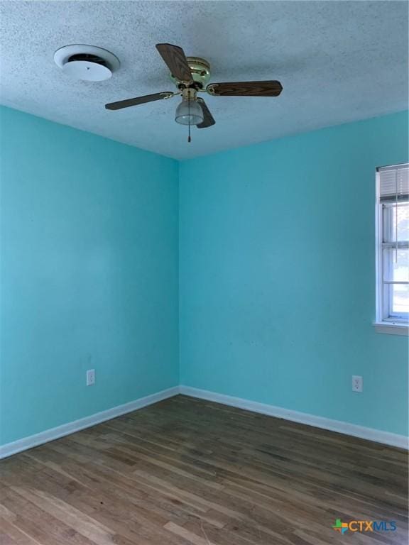 701 S 19th St, Copperas Cove, TX 76522 - unfurnished room featuring dark wood-style flooring, ceiling fan, and a textured ceiling