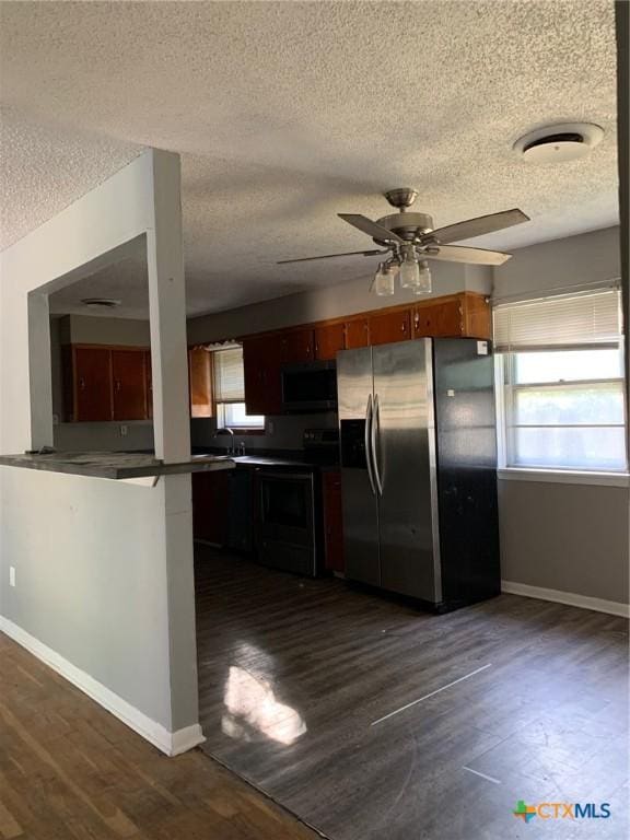 701 S 19th St, Copperas Cove, TX 76522 - kitchen with stainless steel fridge, electric range, a textured ceiling, a ceiling fan, and black microwave
