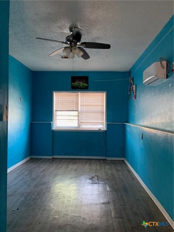 701 S 19th St, Copperas Cove, TX 76522 - unfurnished room featuring a textured ceiling, ceiling fan, a wall mounted AC, and wood finished floors