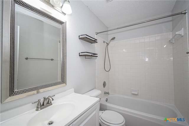 full bathroom with toilet, a textured ceiling, shower / bath combination, and vanity