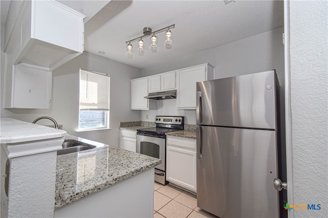 kitchen with appliances with stainless steel finishes, white cabinetry, light tile patterned flooring, and light stone counters