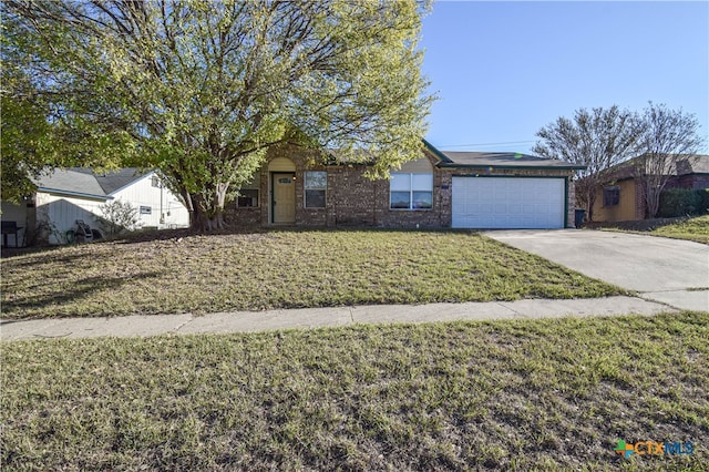 view of front of property featuring a front lawn and a garage