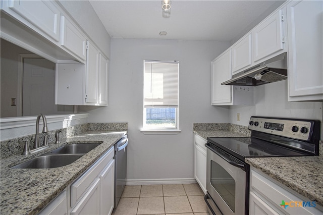 kitchen featuring appliances with stainless steel finishes, white cabinetry, light tile patterned flooring, and sink