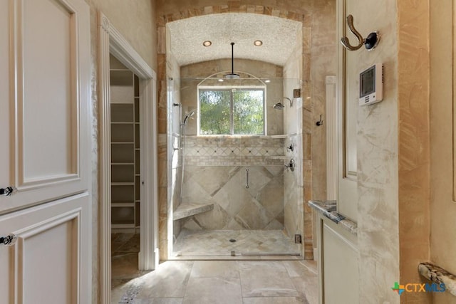 bathroom featuring lofted ceiling and an enclosed shower