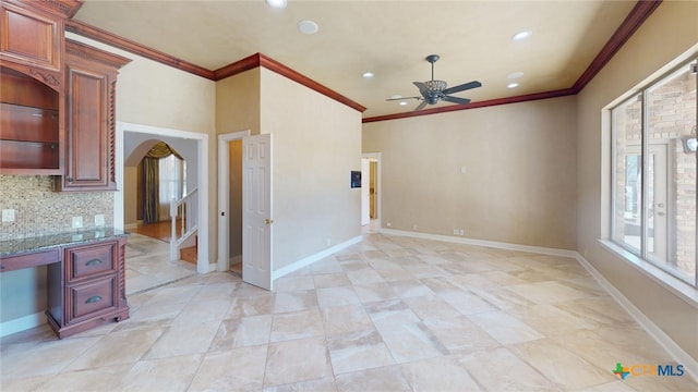 interior space with ornamental molding and ceiling fan