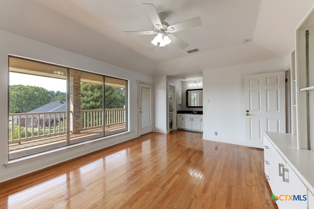 unfurnished living room with ceiling fan, a healthy amount of sunlight, and light wood-type flooring