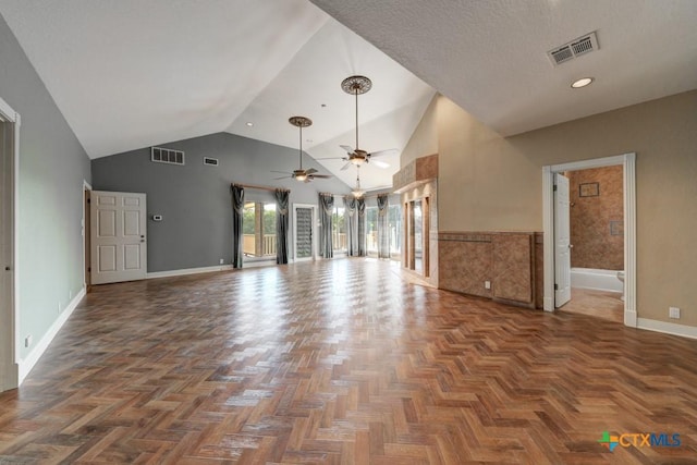 unfurnished living room featuring dark parquet flooring, high vaulted ceiling, and ceiling fan