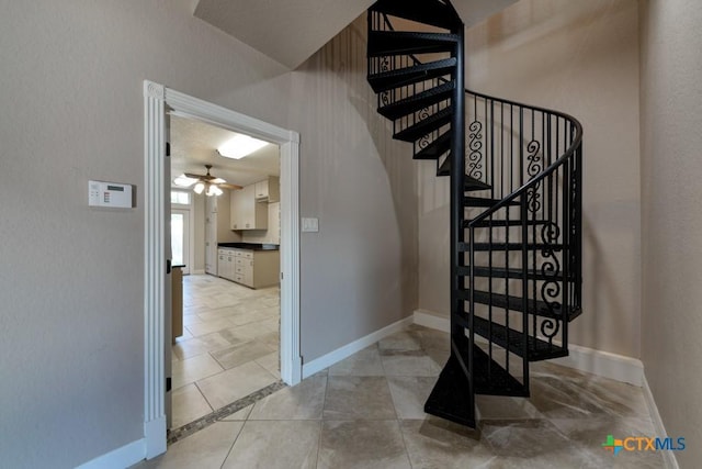 staircase with ceiling fan