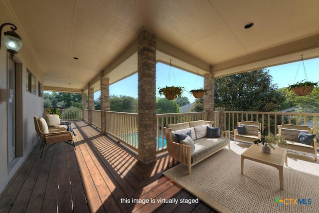 wooden terrace featuring an outdoor living space