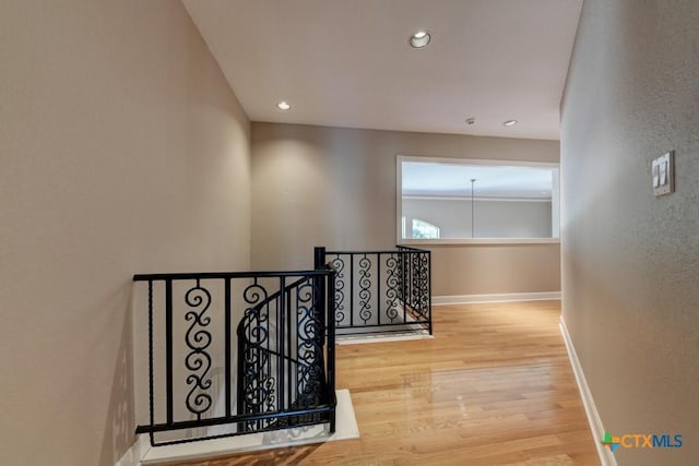 corridor with hardwood / wood-style floors