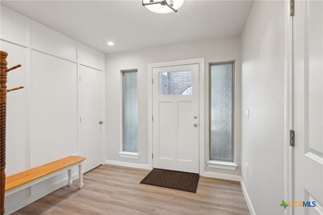 foyer entrance with recessed lighting, baseboards, and light wood-type flooring