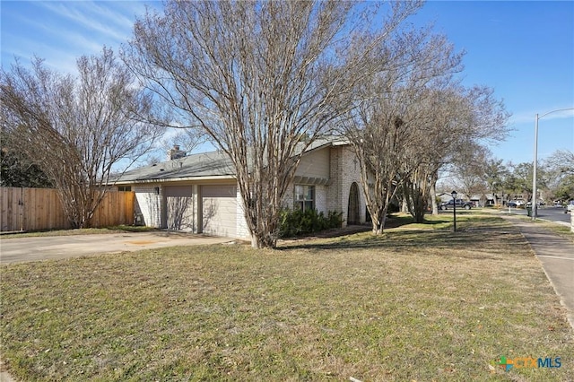 view of front of property featuring a garage and a front lawn