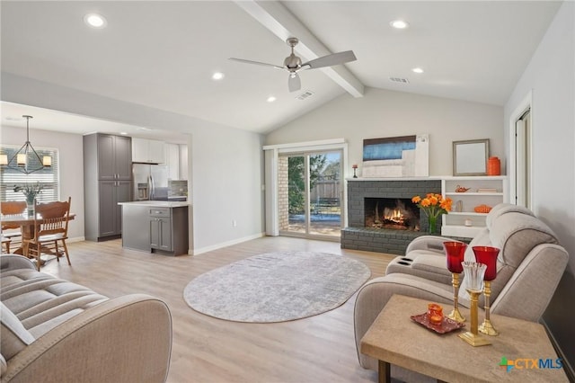 living area with a brick fireplace, vaulted ceiling with beams, a ceiling fan, visible vents, and light wood-style flooring
