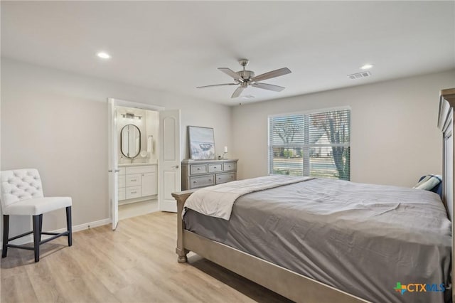 bedroom with connected bathroom, light hardwood / wood-style floors, and ceiling fan