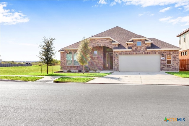 view of front of house with a front yard and a garage