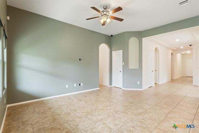 4004 Brookhaven Dr, Temple, TX 76504 - spare room featuring arched walkways, a ceiling fan, baseboards, and light tile patterned flooring