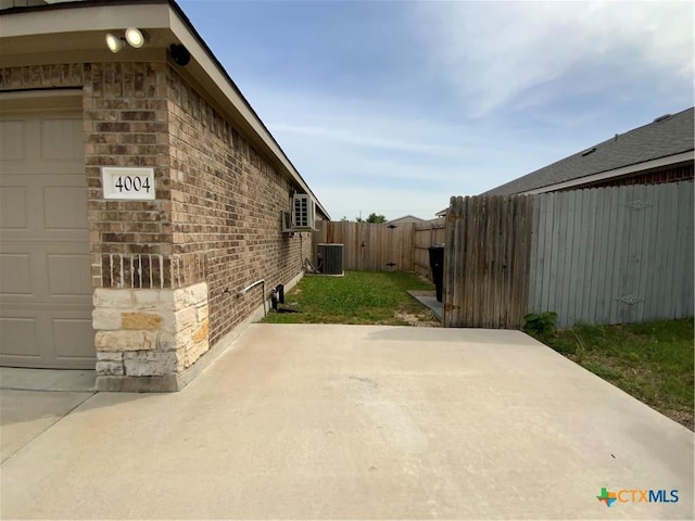 4004 Brookhaven Dr, Temple, TX 76504 - view of property exterior with stone siding, a patio area, cooling unit, and brick siding