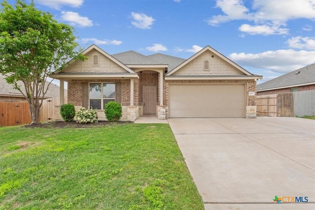 ranch-style house featuring a front yard, a garage, brick siding, fence, and concrete driveway