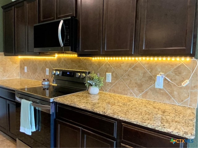 4004 Brookhaven Dr, Temple, TX 76504 - kitchen featuring stainless steel appliances, light stone countertops, backsplash, and dark brown cabinets
