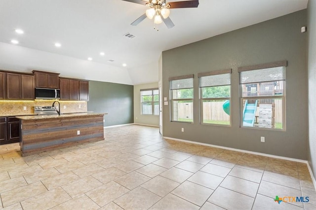 kitchen featuring visible vents, tasteful backsplash, a ceiling fan, appliances with stainless steel finishes, and vaulted ceiling