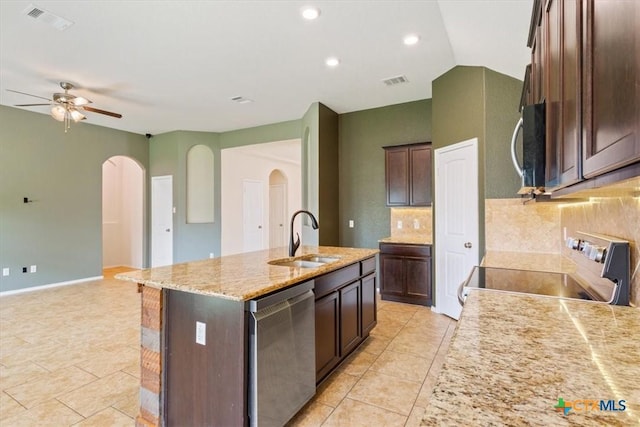 4004 Brookhaven Dr, Temple, TX 76504 - kitchen featuring stainless steel appliances, a sink, arched walkways, a ceiling fan, and a center island with sink