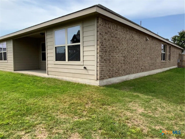 4004 Brookhaven Dr, Temple, TX 76504 - view of home's exterior with brick siding, a lawn, and a patio area