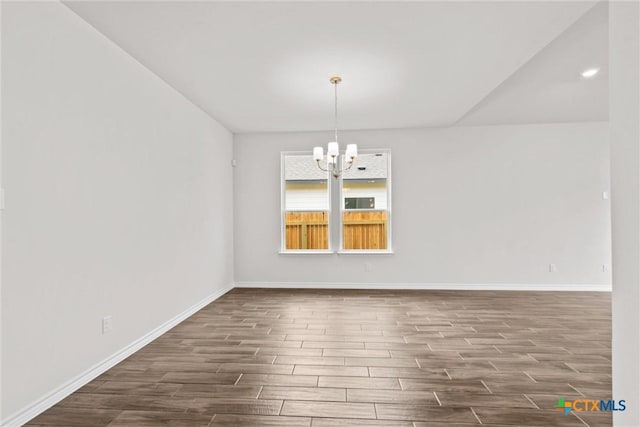 812 Waylon Cir, Killeen, TX 76542 - unfurnished room featuring dark wood-style flooring and a chandelier