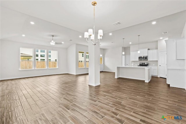 812 Waylon Cir, Killeen, TX 76542 - unfurnished living room featuring recessed lighting, wood finished floors, and a chandelier