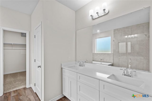 812 Waylon Cir, Killeen, TX 76542 - full bath featuring wood finished floors, a shower stall, double vanity, and a walk in closet