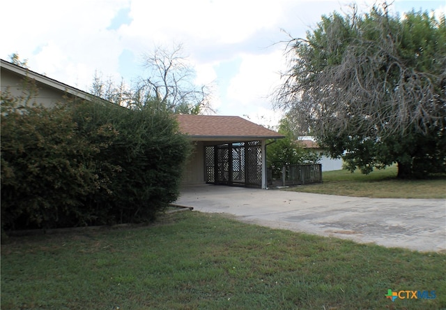 view of front facade with a front yard and a carport