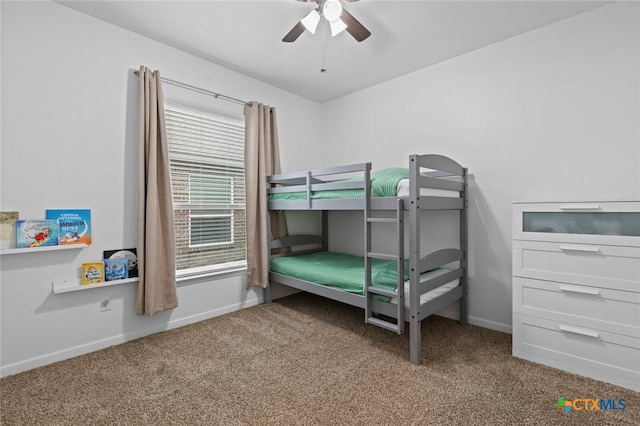 carpeted bedroom featuring baseboards and a ceiling fan