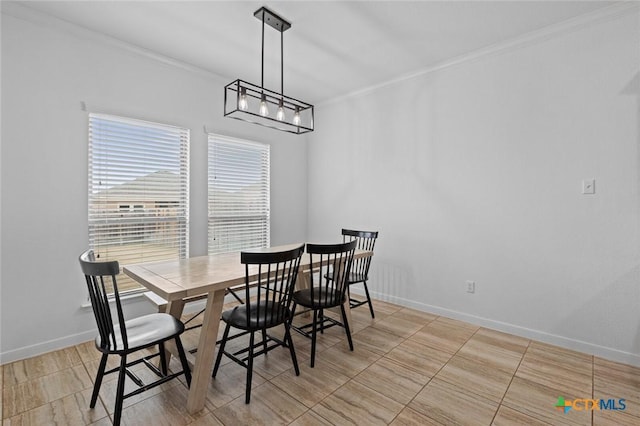 dining area featuring baseboards and crown molding