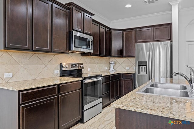 kitchen featuring a sink, tasteful backsplash, appliances with stainless steel finishes, and ornamental molding