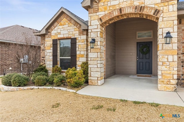 view of exterior entry with stone siding