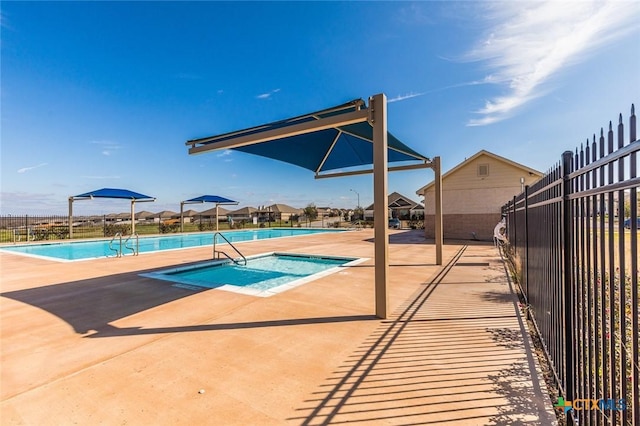 community pool with a patio and fence