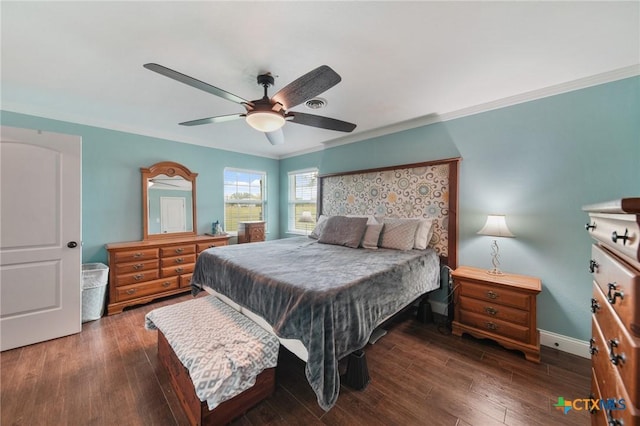 bedroom with crown molding, baseboards, and wood finished floors