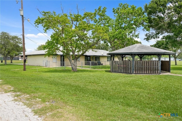 exterior space featuring a gazebo, fence, and a carport