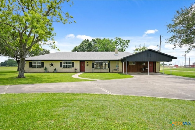 ranch-style house with driveway, a chimney, a front lawn, and a carport