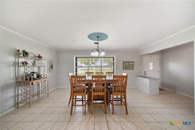 dining room featuring crown molding, an inviting chandelier, and light tile patterned flooring