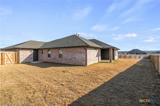 rear view of house with a lawn