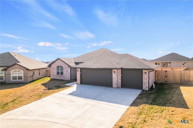 view of front of property featuring a garage and a front yard