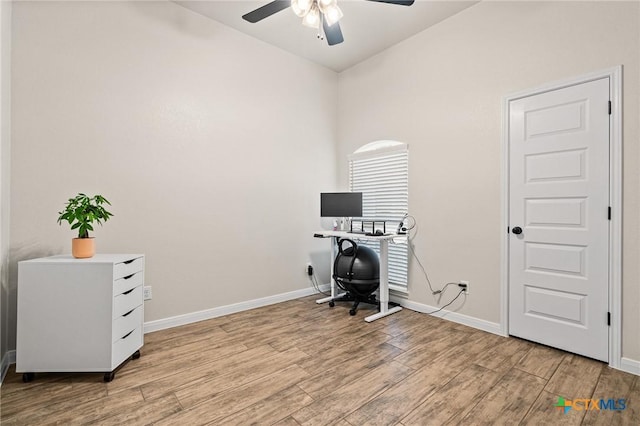 home office featuring light hardwood / wood-style floors and ceiling fan