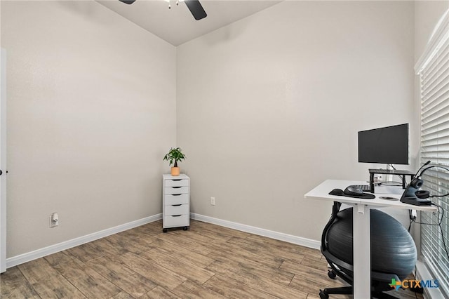 home office featuring ceiling fan and light hardwood / wood-style flooring