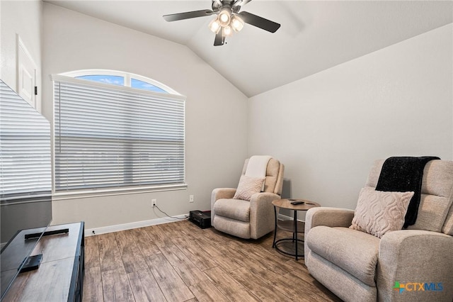 living area featuring hardwood / wood-style flooring, lofted ceiling, and ceiling fan